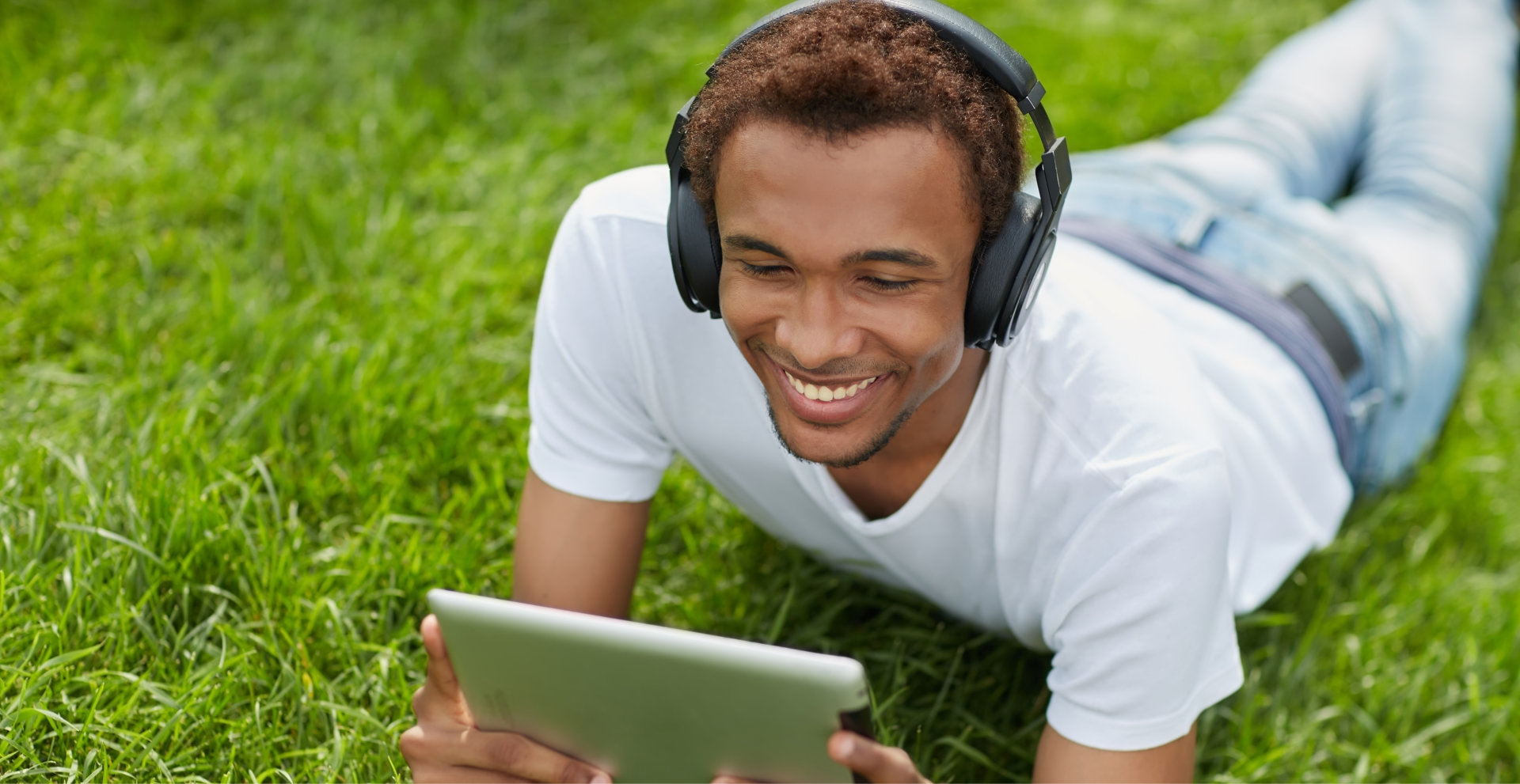 smiling young man looking at the tablet devices