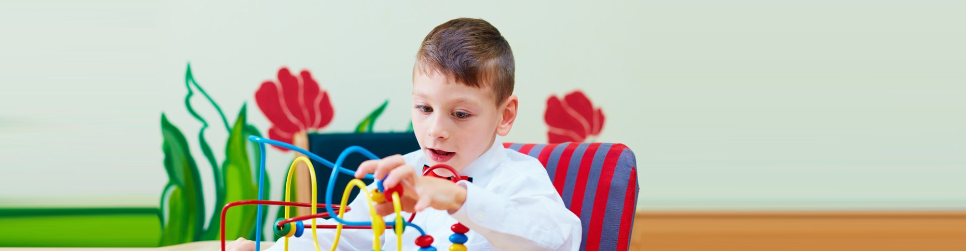 little boy trying to solve a puzzle