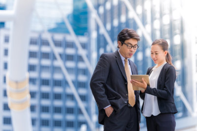 man and woman looking for appointment with their tablet device