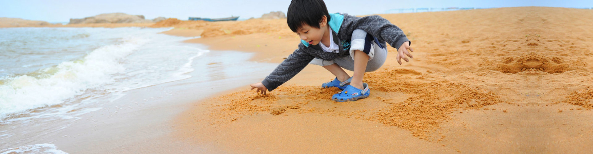 boy playing on the beach