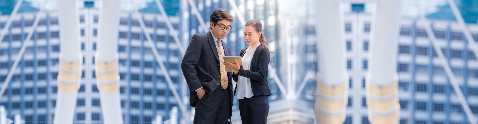 man and woman looking for appointment with their tablet device